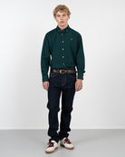 Camisa ICON COLORS verde botella de Harper & Neyer, vista frontal cuerpo entero con vaquero oscuro y sneakers