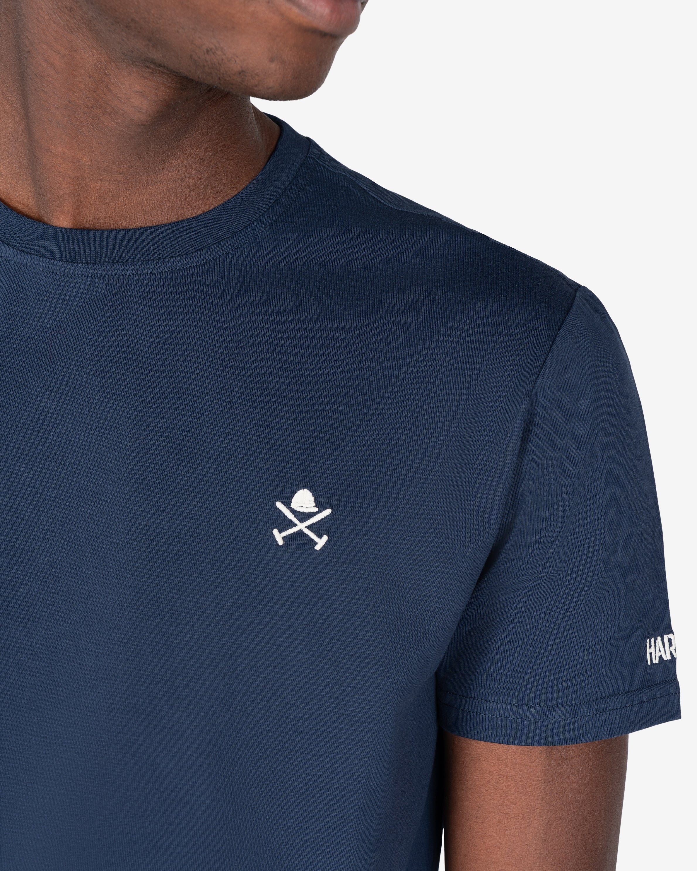 Detalle del emblema bordado de casco y mazos en la camiseta RANGER de Harper & Neyer en azul marino