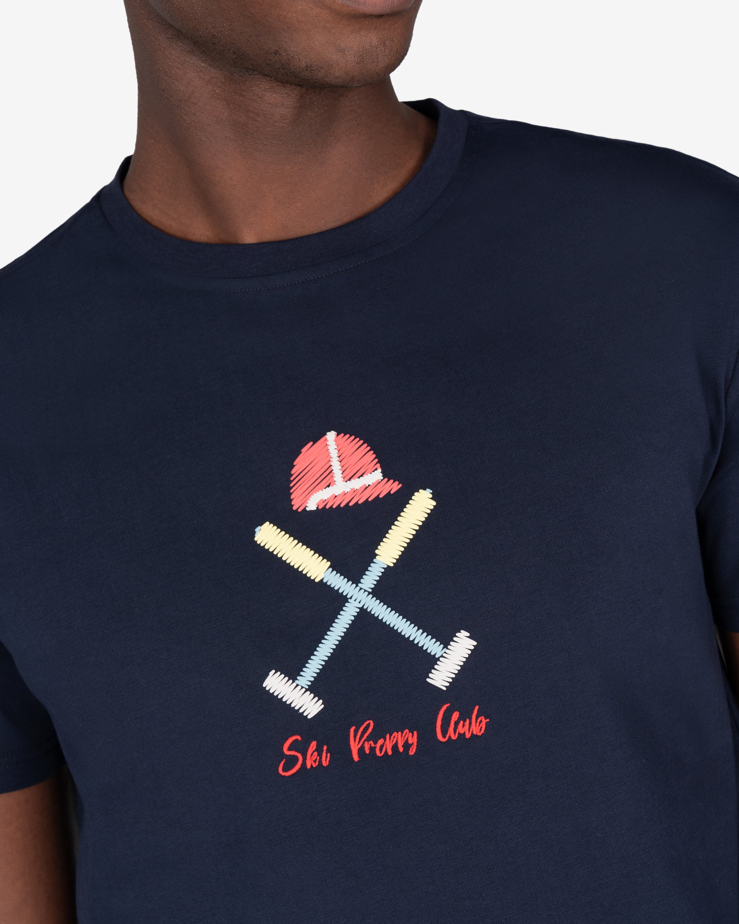 Detalle del bordado Ski Preppy Club en hilo scribble policromo de la camiseta VERMONT azul marino de Harper & Neyer