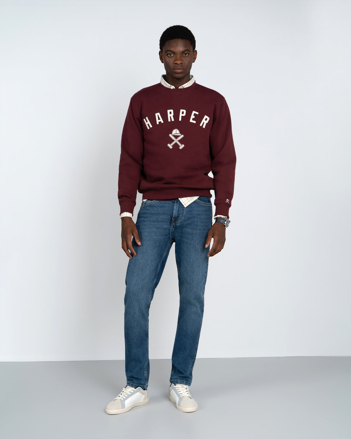 Sudadera New England de Harper & Neyer en burdeos con camisa de cuadros, denim medio y sneakers blancas